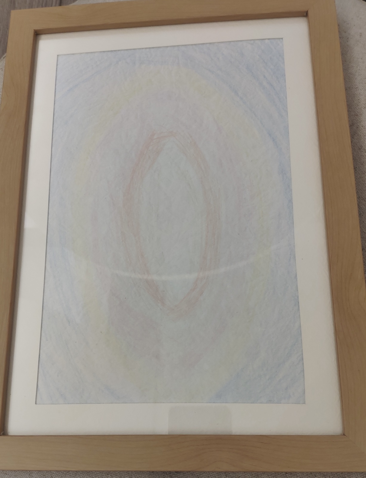 Pale coloured-pencil page: a soft blue and yellow field with a faint pink oval at the centre.