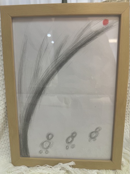 Graphite drawing: a wide sweeping arc rising across the page, a small red dot at its upper end, and three small circular figures below.